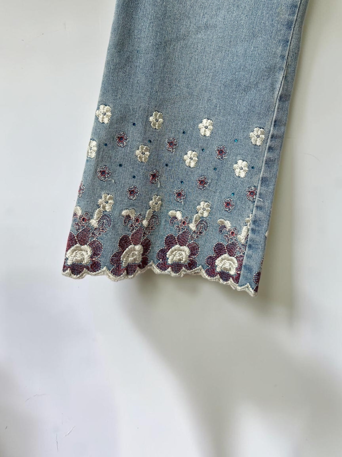 Vintage embellished floral jeans close up